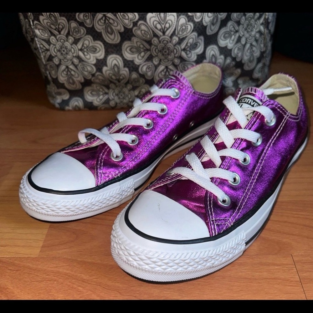 Converse Women’s Chuck Taylor Sneakers in Metallic Magenta.